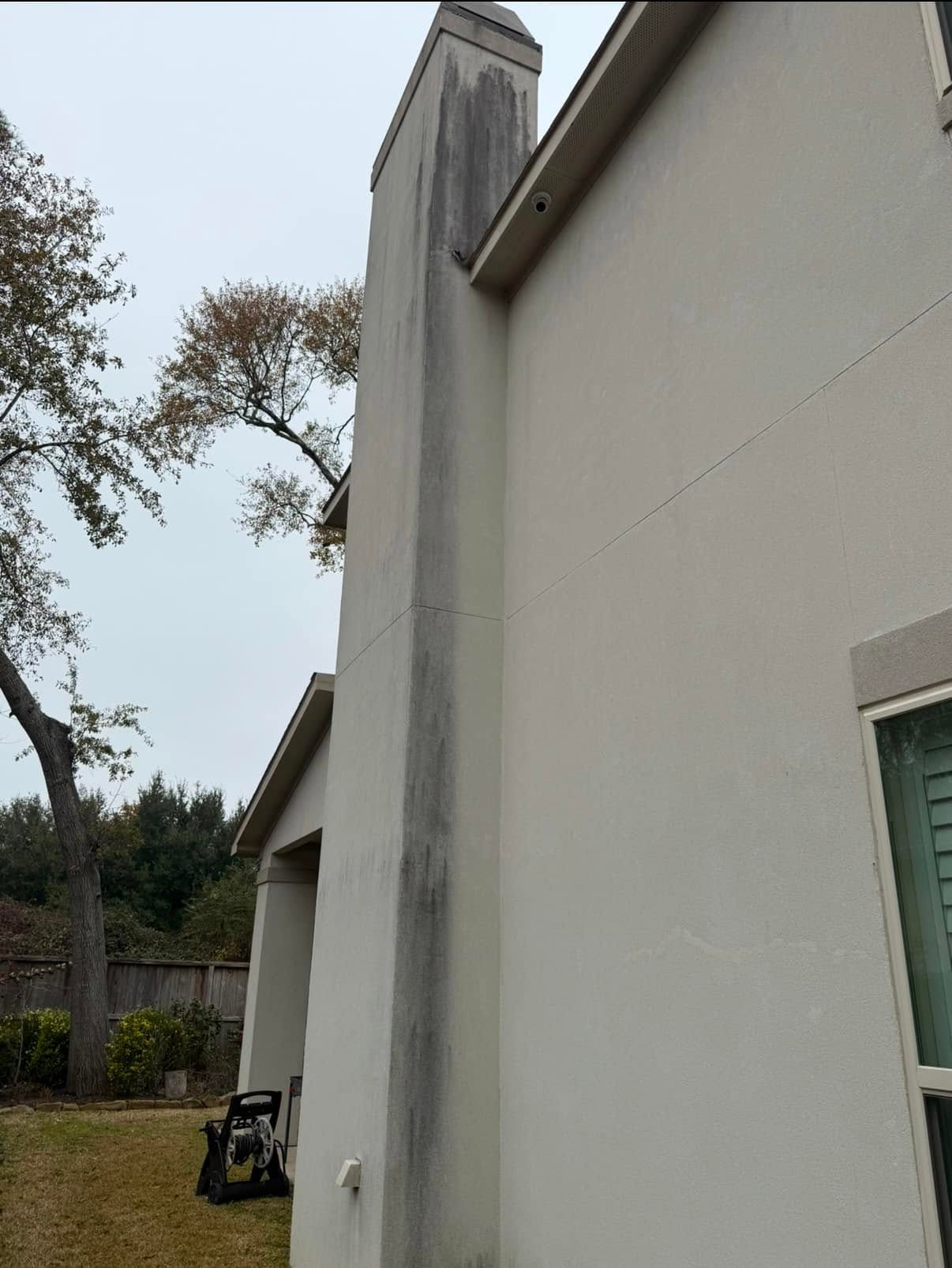 Stucco wall before, streaked with dirt