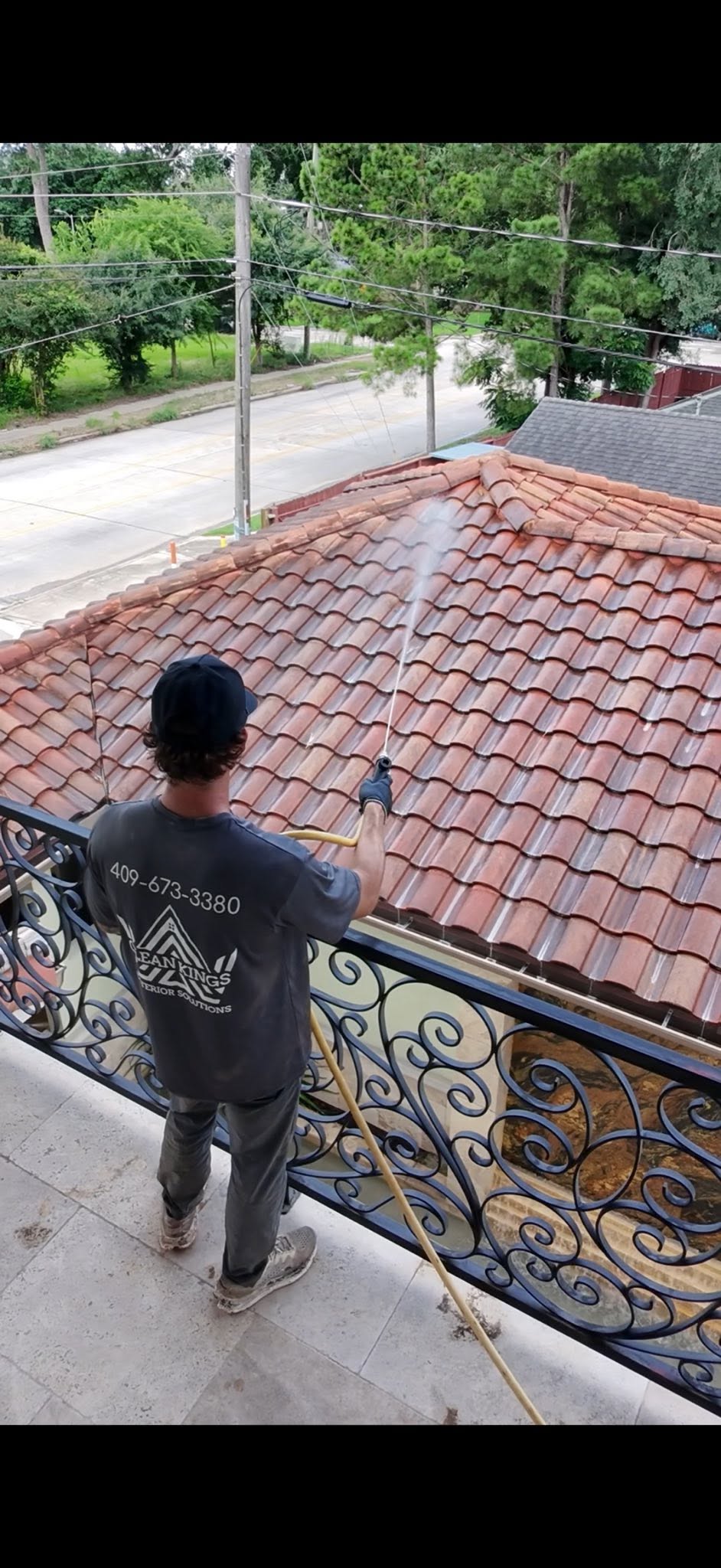 Clean Kings crew soft washing a roof